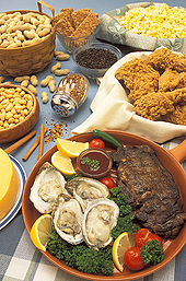 Several plates full of various cereals, fruits and vegetables on a table.